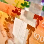 Close up of Canadian banknotes (CAD) background, this is polymer money with holograms that will last longer and be harder to counterfeit.