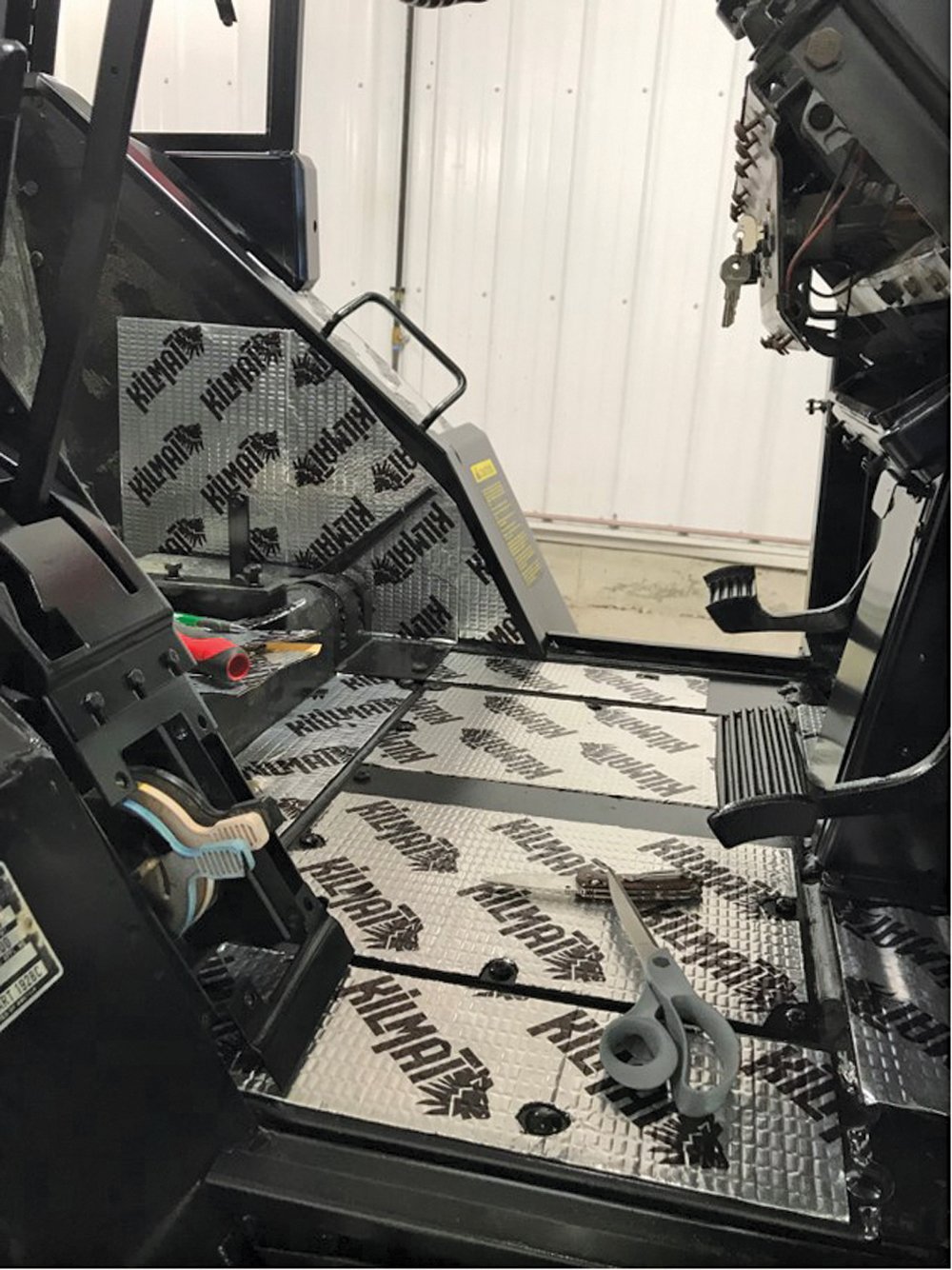 New upholstery was purchased from a supplier and installed after the cab was repainted and given a layer of sound deadening material.