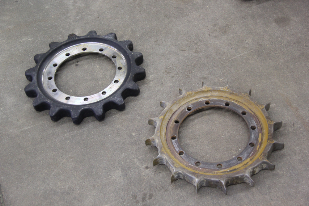 These two drive gears show the difference in wear between a new gear from another competitive brand compared to one with only 300 hours of use at the proving grounds. The abrasive conditions crated by accumulation in a closed track module accelerated the wear rate.