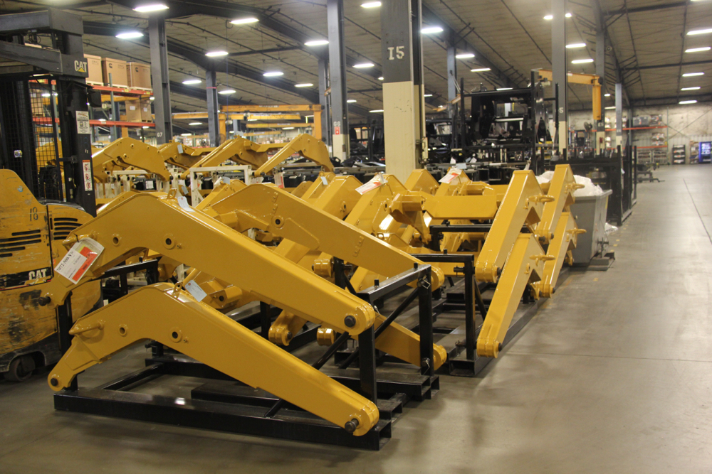 Loader arm sub assemblies arrive at the plant from a supplier and wait their turn to head to the assembly line.