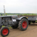 This Minneapolis Moline Twin City tractor pulled a trailer along the route, but on closer inspection, there was something very unusual about the hook up between them. A shaft ran from the tractor’s PTO to an old truck axle under the trailer.
The owner explained that they really wanted to put the old MM into the trek, but with a top speed of around five miles per hour, it would have been impossible to keep up. So the owners came up with a clever solution. A shaft from the PTO linked to the truck axle under the trailer, which let the trailer push the tractor. The gear ratio that created allowed the tractor to make over 12 m.p.h.