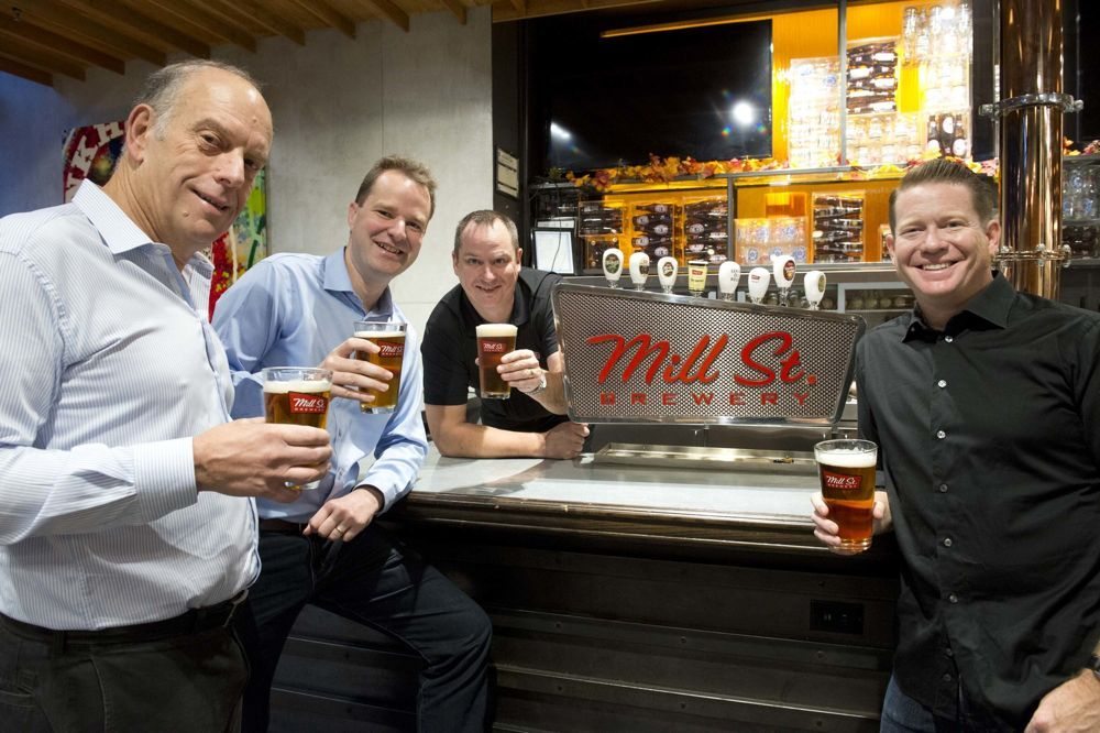 Mill Street CEO Irvine Weitzman, Labatt president Jan Craps and Mill Street’s brewmaster Joel Manning and co-founder Steve Abrams (l-r) on Friday announced Labatt has bought the Toronto craft beer company. (CNW Group/Labatt Breweries of Canada)
