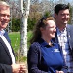 Premier Dwight Ball, provincial grain research specialist Dr. Vanessa Kavanagh and Christopher Mitchelmore, minister for the Forestry and Agrifoods Agency, watch the seeding of Newfoundland and Labrador’s first canola field. (Gov.nl.ca)