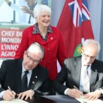 University of Guelph president Dr. Franco Vaccarino (right) and Ontario Agriculture Minister Jeff Leal sign a new research partnership agreement, with Guelph-area MPP Liz Sandals. (John Greig photo)