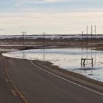Cattle producers and feeders in some areas of southern Alberta have been dealing with overland flooding, such as shown here Saturday over Highway 36 south of Vauxhall, and otherwise mushy conditions. (Photo courtesy Taber RCMP)
