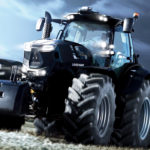 Occupying the flagship spot in Deutz Fahr’s North American line is the 9340 TTV Warrior tractor with 316 horsepower under the hood. The “Warrior” model, which is also available as a 7250 TTV, is the brand’s premium, “limited edition” tractor. The maximum power rating on the 9340 offers another 20 horsepower, bringing the tractor up to 336 horsepower when needed. The 7250 is rated at 230, but jumps to 246 with its maximum horsepower rating.
The Warriors mate their Deutz-Fahr-built diesel engines — a 6.1 litre in the 7250 and a 7.8 litre version in the 9340 — to the brand’s TTV continuously variable transmissions, which offer both “Auto” and “Manual” driving functions. The TTV can creep the tractors along as slow as 0.2 km/h. or move them down the road at up to 60 km/h. at reduced engine RPMs.
The Warriors can be made to stand out from their brothers in the Deutz-Fahr tractor lines with a unique black paint scheme, or they can also be ordered in standard Deutz-Fahr green.
At e rear the 9340 has a three-point hitch lift capacity of 12,000 kilogram and an optional hydraulic output hits 210 l/min. 160l/min. is standard. The 7250 gets a rear lift rating of 10,000 kilograms and a hydraulic pump that can push out 120 l/min. That can jump up to 160 as an option. Both models use a load-sensing pump.
Like the other tractors, inside the cab Warriors use the brand’s 12-inch iMonitor 2.0 to handle tractor data and precision farming functions. The iMonitor is capable of handling ISOBUS-compatible implement functions. It can also handle input from up to two remote cameras.
The 9 Series TTV Agrotron line includes three models that offer 277 to 316 horsepower with 40, 50 and 60 km/h. transmission options. In the 7 Series, there are two standard models, the 7230 and 7250 that offer engine horsepower ratings of 214 and 230.
Deutz-Fahr offers tractors equipped with adaptive front suspension that includes front dry-disc brakes on tractors. A booster system allows for maximum brake pressure with only light pedal application.