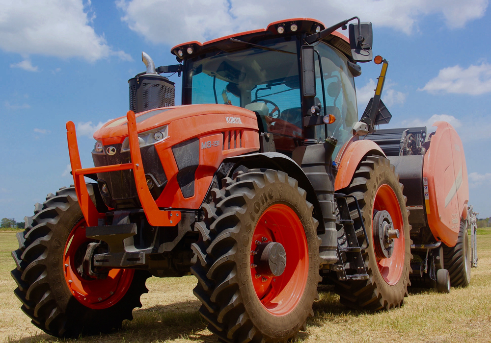 “We’re not here as a flavour of the month,” Bob Hickey, president of Kubota Canada told the brand’s dealers at the introduction of the new M8 tractor line in Texas in July, 2019. And all the messages telegraphed by management at that event clearly indicate Kubota intends to keep driving toward a fuller market share in the ag equipment sector. The M8 tractor line is a key step in that direction.
The two new tractors that make up the M8 Series take up where the M7s leave off. (The M7s top out at 168 engine horsepower.) There are two models: the 190 engine horsepower M8-191 and 210 horsepower M8-211. These tractors will, as expected, share a base platform with Versatile’s Nemesis line and will be built for Kubota in Winnipeg at Versatile’s assembly plant.
A 6.7-litre Cummins will supply the muscle that can be routed through a fully electronic 30x15 power shift transmission, which includes a shuttle shift with either a 40 or 50 km/h. top speed. Or the tractors can be equipped with an optional 50 km/h.-capable CVT. The powershifts offer six on-the-go gear changes in each range. And the transmission will auto shift up to a pre-set speed as well as downshift when the engine lugs down to a pre-set limit, making this a simple tractor to operate.
These MFWD tractors can be equipped with a rigid or suspended front axle. The suspended-axle versions also get cab suspension to significantly soften the ride for an operator. 
At the rear, a 540 or 1,000 r.p.m. PTO can be operated in both standard and eco modes. A 1¾-inch, 20-spline shaft is also available as an option. Three-point hitch lift capacity is 5,660 kilograms, but that can be raised to 7,050 as an optional feature.
A hydraulic flow rate of 120 l/min. is standard, but that can be boosted up to an optional 160. Three rear remotes are standard, with five as an option there.
With 148 cubic feet of interior space, the cab is larger than the M7’s, but the control armrest is identical. Inside the cab, a seven- or 12-inch LCD touch screen monitor is fully ISOBUS compatible, allowing the tractor to maximize communication with any compatible implement from any brand. Built into the tractor’s brain is a customizable headland control feature to automate turns in the field. And Kubota has decided to use an open architecture system to make the tractor compatible with any GPS auto-steer system currently on the market. 
Kubota will also allow buyers to pair an M8 with the new self-levelling M77 front-end loader, which includes shock-absorbing hydraulic accumulators that cushion the tractor and loader arms from hard shocks when going over rough terrain. 
The joystick that controls the loader has a third-function feature that allows for grapple control. And there is even a fourth function available as an upgrade. The M77 loader has a 2,360-kilogram load rating at maximum lift height and a breakout force rating of 4,600 kilograms. So these tractors offer capacities well beyond what most utility category tractors can offer.
