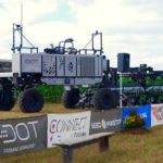 The U-shaped DOT A-U1 “loads” a SeedMaster row-crop planter on to its platform during a demonstration at Canada’s Outdoor Farm Show in September 2019. (Ralph Pearce photo)