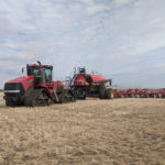 This Vaderstad drill, pulled by a Case IH track tractor, helped seed part of the Field of Excellence field-scale applied research plot where variable-rate seed and fertility treatments are being evaluated.