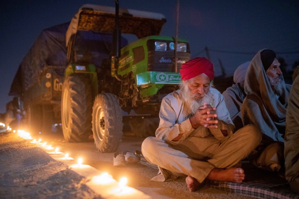 A farmer prays to mark the 551st birth anniversary of Guru Nanak Dev, the first Sikh Guru and founder of Sikh faith, at Singhu border near Delhi on Nov. 30, 2020, at the site of a protest against newly passed farm bills. (Photo: Reuters/Danish Siddiqui)
