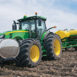 Goodyear Super Single Low Sidewall technology tires on a John Deere 8R series tractor. With this tire setup, total contact area is increased to 3,644 inches from 2,368 inches, which means healthier soil from a compaction standpoint.