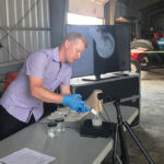 Mike Cowbrough is the weed management lead, field crops, with OMAFRA and co-curator of sprayers101.com. In the photo, Cowbrough shows his audience how mixing order can affect product compatibility in tank mixes.