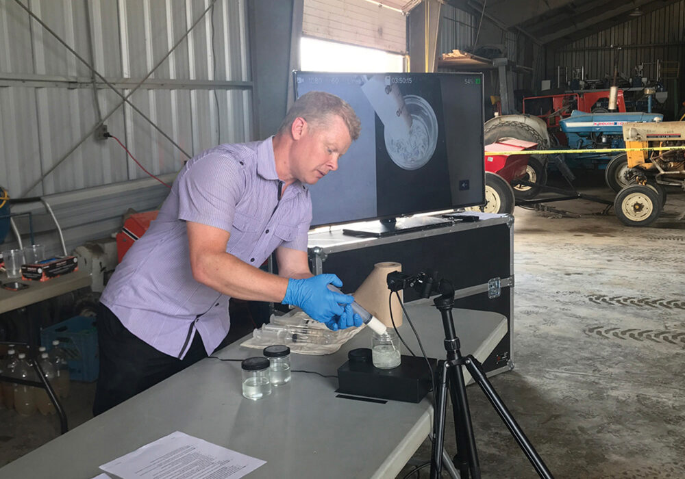 Mike Cowbrough is the weed management lead, field crops, with OMAFRA and co-curator of sprayers101.com. In the photo, Cowbrough shows his audience how mixing order can affect product compatibility in tank mixes.