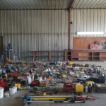 The parts and tools contents of the workshop, organized by likeness, after emptying all of the shelves and drawers — and after a cursory cull.