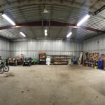 The full panorama of our workshop following the completion of my first round of organization (there is more to come). I purchased two of the shelving racks, one of which is situated in the centre of the back wall and the other along the wall on the left. They are sturdy, deep enough and a great way to keep items off of the floor.