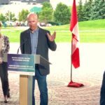Manitoba Beef Producers president Tyler Fulton speaks in Winnipeg on July 22, 2021 at a federal/provincial announcement including planned changes to crop insurance against this summer’s drought, alongside federal Agriculture Minister Marie-Claude Bibeau and Winnipeg MP Kevin Lamoureux (r). (Dave Bedard photo)