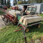Hardman can be seen in this photo near a tractor and seeder. He’s holding a grain scoop to fill the seeder by hand, something he had to do all the time before fill augers became relatively commonplace. “That’s really old school. It builds up some muscles,” he says, laughing.