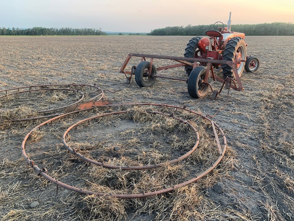 Those two large metal circles attached to the back of the tractor are harrows. Hardman notes they date back to the 1940s or ’50s. They leave a “wiggly, squiggly” pattern in the soil because they are constantly moving and cleaning themselves when in use, he says.