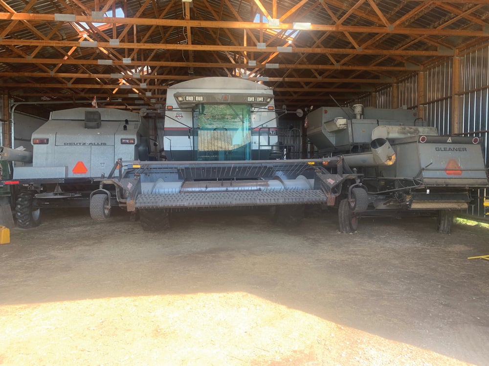 Hardman refers to these three combines as his Gleaner trifecta. The one in the middle is a 1998 rotary model and is the newest of the three. The other two models were manufactured in 1982 and 1989.