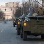 A Ukrainian service member is seen atop of an armoured personal carrier in Kyiv on Feb. 25, 2022. (Photo: Reuters/Valentyn Ogirenko)