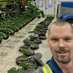 As part of the proper annual maintenance of a row planter, technician Andrew Kippen removes row units to have a look deep inside the seeding system.