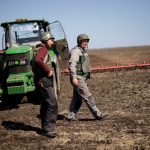 Yuri and Oleksiy, farmers wearing body armours and helmets, prepare for field work in Ukraine’s Zaporizhzhia region amid Russia’s invasion, on April 26, 2022. (Photo: Reuters/Ueslei Marcelino)
