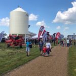 Visitors walk the grounds at Ag in Motion on July 19, 2022 after taking cover from a rain shower. (Liam O’Connor photo)