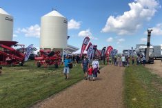 Visitors walk the grounds at Ag in Motion on July 19, 2022 after taking cover from a rain shower. (Liam O’Connor photo)