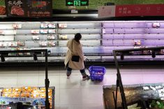 A customer looks at food items displayed on shelves at a supermarket, amid the COVID-19 outbreak in Shanghai, China on Nov. 30, 2022. (Photo: Reuters/Aly Song)
