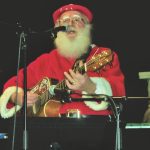The Singing Santa belts out Rudolph the Red-Nosed Reindeer before a live audience at the Jingle Bell Breakfast.