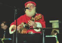 The Singing Santa belts out Rudolph the Red-Nosed Reindeer before a live audience at the Jingle Bell Breakfast.