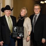 Alumni of Canada’s Outstanding Young Farmers program Ian (left) and Karilynn (middle) Marshall of Bowden, Alta., receive the W.R. Motherwell Award from COYF president, Danny Penner (right), at the COYF national award ceremony in November.
