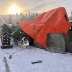 It wasn't necessarily pretty but the tarp set up got the job done at -35C temperatures. The insulated tarp along with plywood skirting provided a temporary shelter, while portable heaters warmed the rear tire enough so it could be removed and repaired.