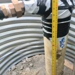 It was sort of a happy accident that the manhole creating access to waterline connections had to be dug a bit deeper. It provides more room for working. The manhole casing is a 40" diameter culvert, about 14 feet long.