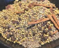 Dry roasting whole spices in a cast iron pan.