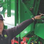 Yancy Wright, go-to-market manager for production updates at John Deere, points out the remote separator grate covers available as a retrofit upgrade for X9 combines.