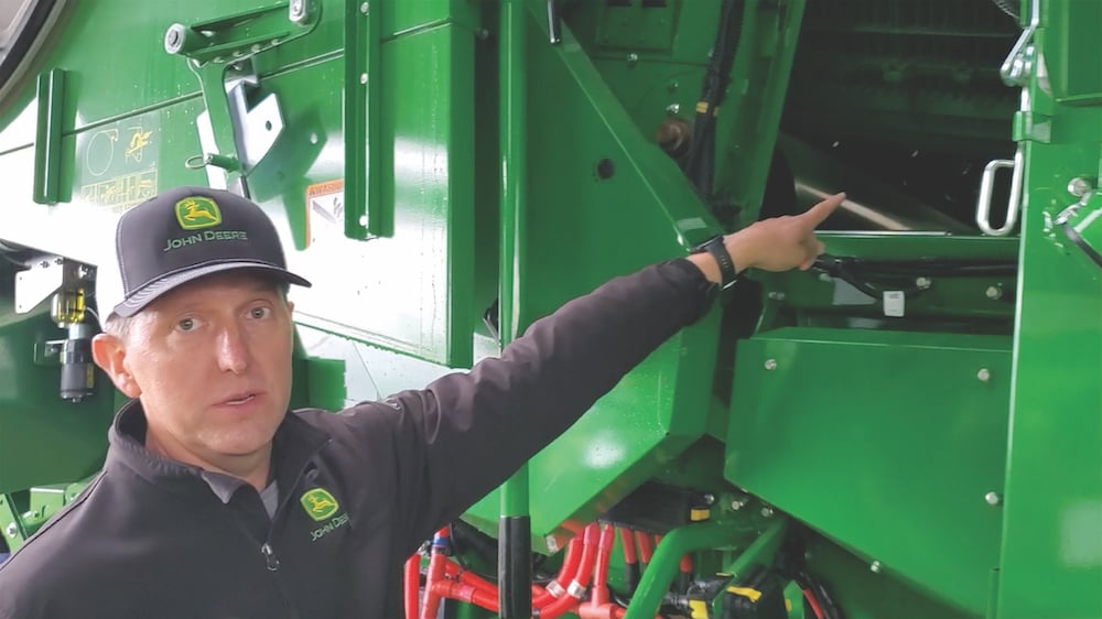 Yancy Wright, go-to-market manager for production updates at John Deere, points out the remote separator grate covers available as a retrofit upgrade for X9 combines.