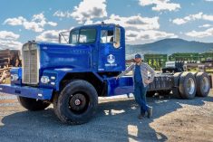Edison Motors' CEO Chace Barber stands beside the company's first concept truck, a 1962 LW900 Kenworth converted to diesel-electric hybrid drive.