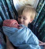 Ian gets to know his new baby sister Anna.