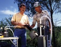 A hydrologist and a farmer draw water from a 30-foot sampling well in western Iowa, testing for nitrate and herbicides.