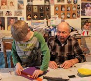 Grandpa Lynn oversees one of Joseph's art projects. Grandma's walls are covered with grandkid artwork and Joseph is a proud contributor.