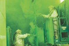 Workers on a paint assembly line at Deere and Co.'s seeding equipment manufacturing plant at Moline, Illinois in 2016.