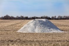 a pile of lime awaiting application on a farm field
