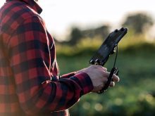 farmer piloting drone in canada
