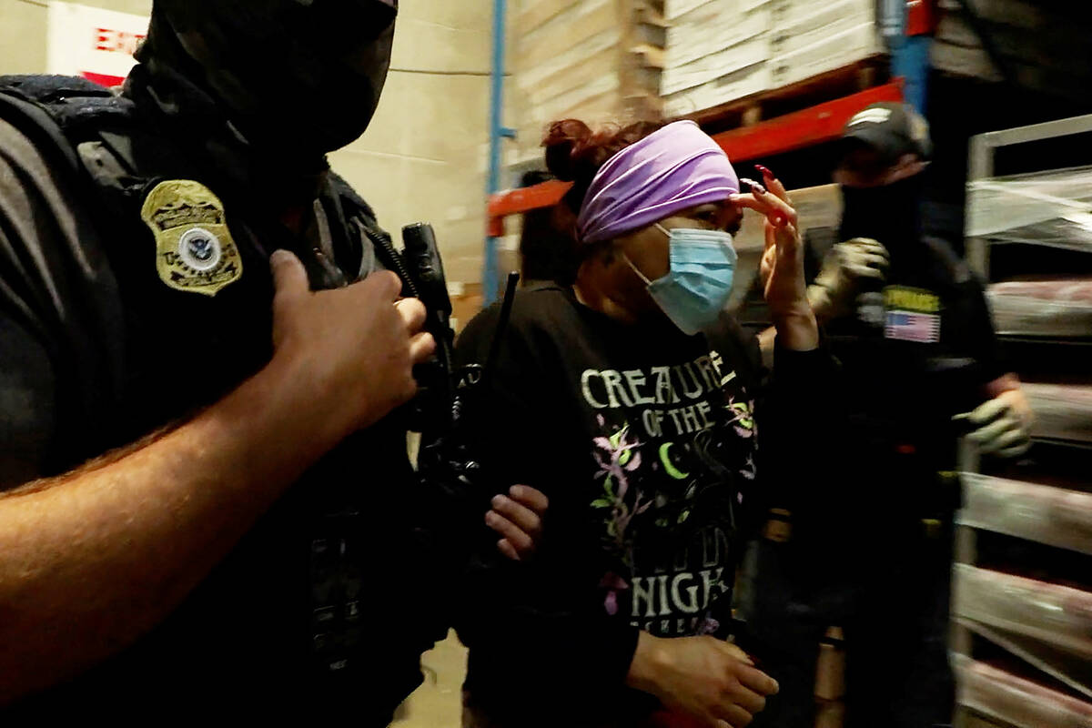 A woman is detained during a raid by U.S. Immigration and Customs Enforcement (ICE) at a Glenn Valley Foods meat production plant in Omaha, Nebraska, U.S. June 10, 2025 in a still image from video. Photo: U.S. Immigration and Customs Enforcement/Handout via Reuters

