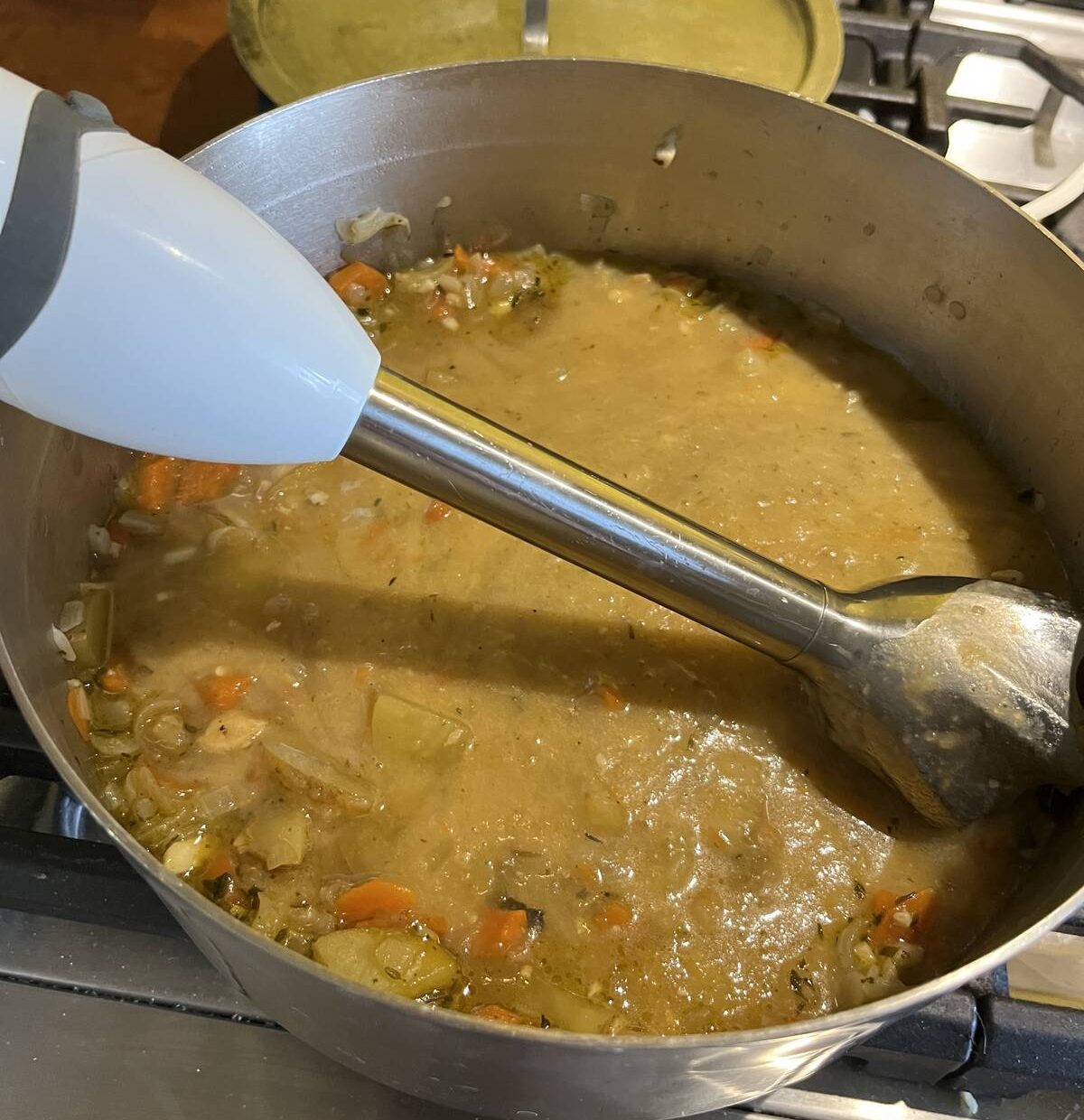 An immersion wand makes short and safe work of pureeing soup on the stovetop.