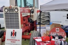 a classic red International Harvester tractor surrounded by brand memorabilia