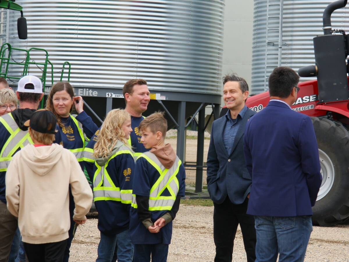 Pierre Poilievre at Sixteen Grains near Saskatoon, Sask. speaking to one of the farm owners.
