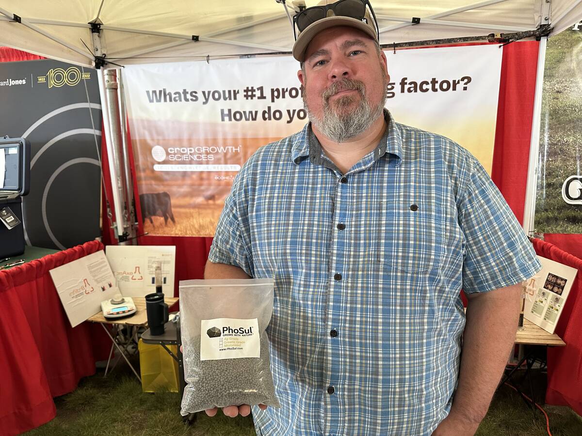 Darcy Lepine, President of Crop Growth Health, displaying his new product, PhoSul. Photo: Don Norman