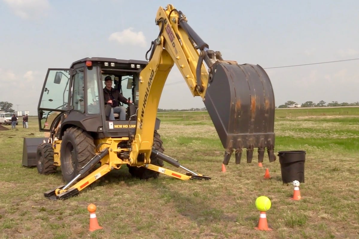 Scott Garvey operating a backhoe at the Ag in Motion farm show